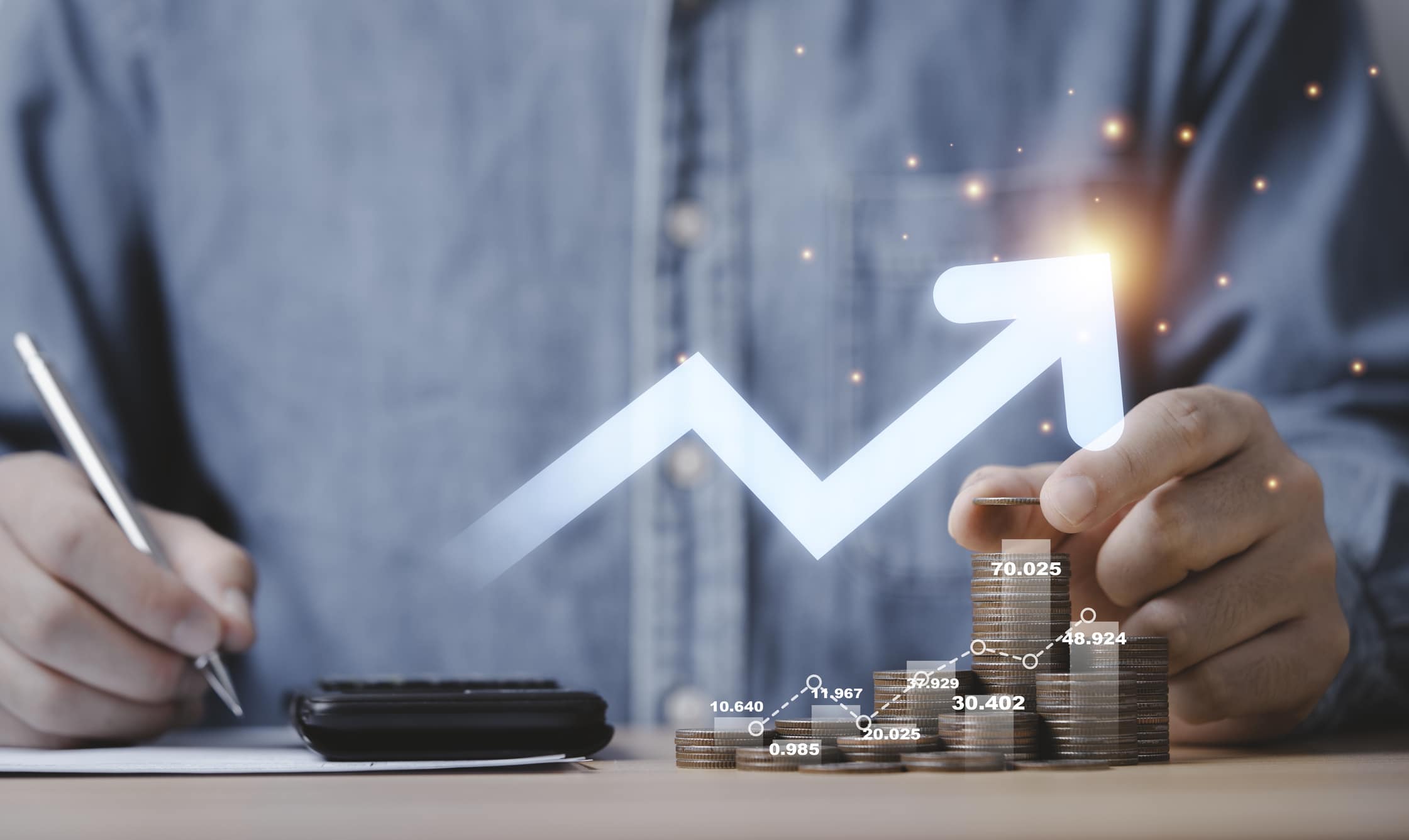 Businessman hand drawing virtual increasing graph with money coins stacking , Business investment profit and deposit dividend saving growth concept.
