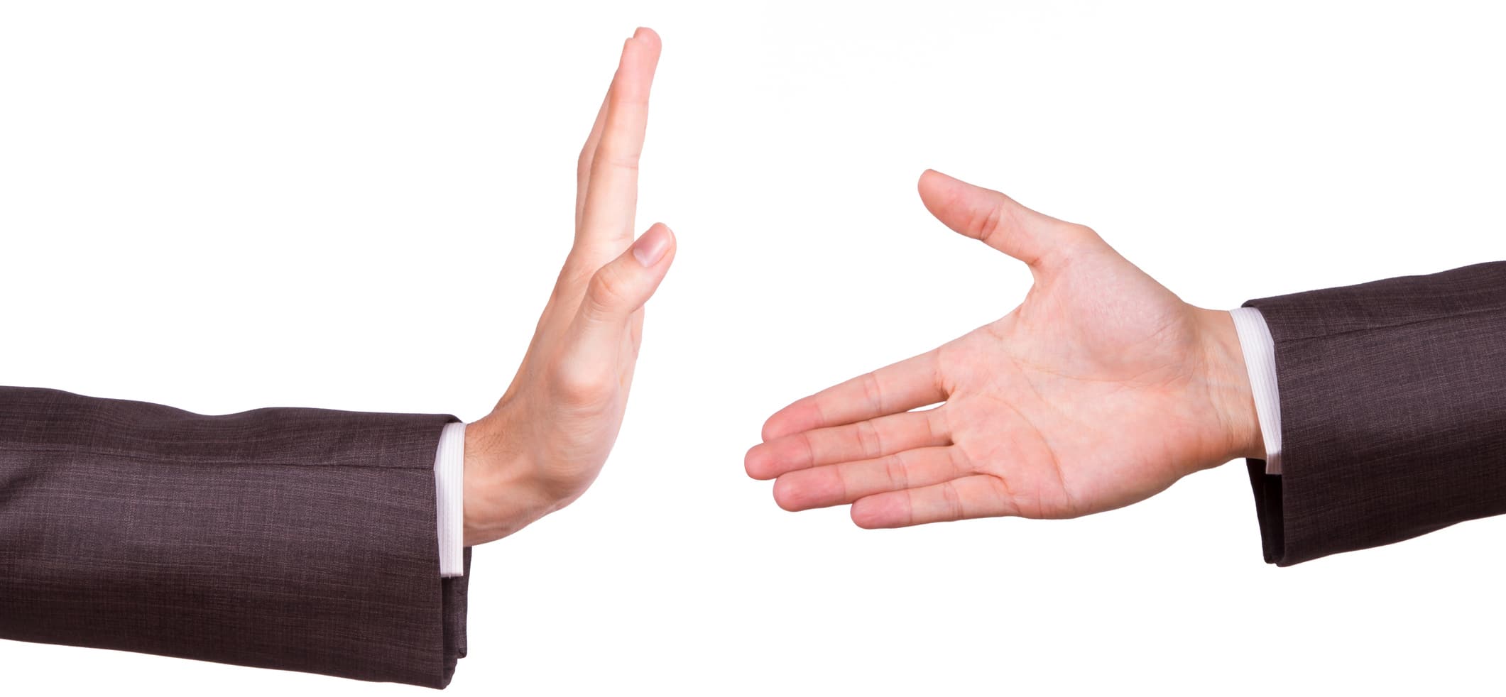 Businessman hands, one of reaching for handshake, the other gesturing stop sign, isolated on white background.