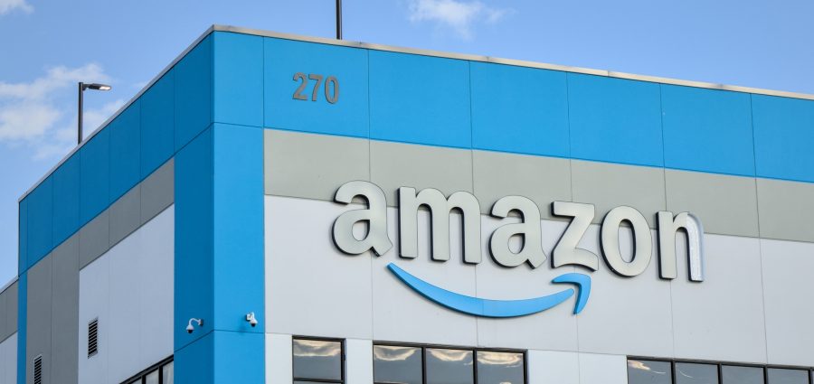 Amazon company logo with damaged letter 'n' on warehouse office building in Red Hook, Brooklyn, New York City.
