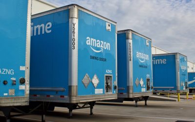Miami, Florida August 17,2019 multiple blue Amzon prime trailers backed into bays at a distribution center to unload products for area customers.