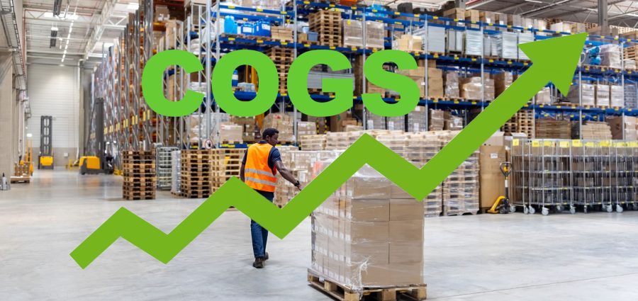 Rear view of a dock worker walking with packages on pallet jack at distribution warehouse. Young male dispatcher pulling pallet jack with boxes.