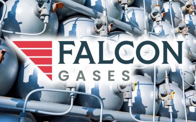 A lot of different small metal bottles filled with gas or gasoline are stacked in large piles and illuminated by the bright warm daytime sun