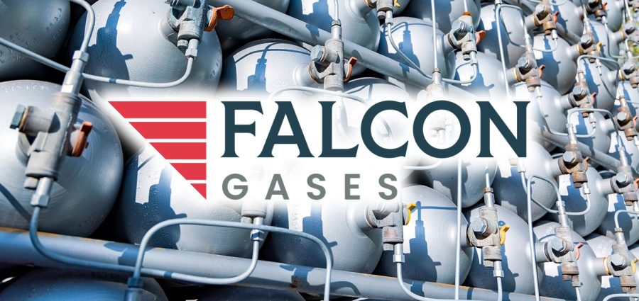 A lot of different small metal bottles filled with gas or gasoline are stacked in large piles and illuminated by the bright warm daytime sun