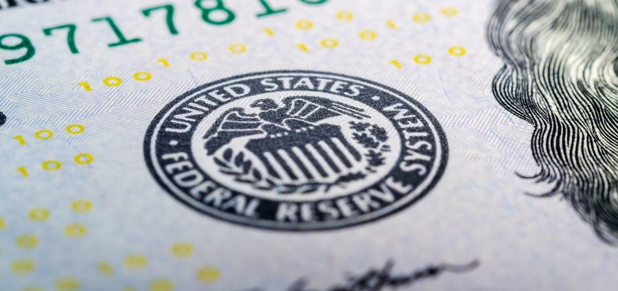 Federal reserve system symbol on hundred dollar bill closeup macro shot