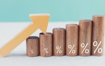 Wooden blocks with percentage sign and arrow up, financial growt