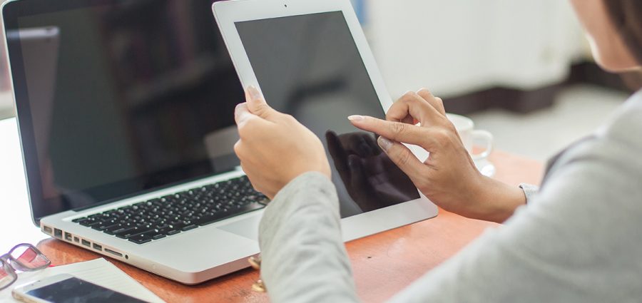 Beautiful business working woman using Ipad while working with l
