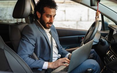 Entrepreneur working from his car, focused on a laptop while managing calls and emails on the gomodern mobile office lifestyle showcasing remote work productivity and connectivity