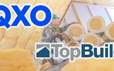 A worker in a helmet and plaid shirt installs insulation in a residential attic, focusing on safety and precision during a daylight renovation project.