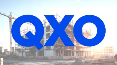 Construction background: A Construction site of large residential commercial building, some already built, large metal structure with bright sky background.