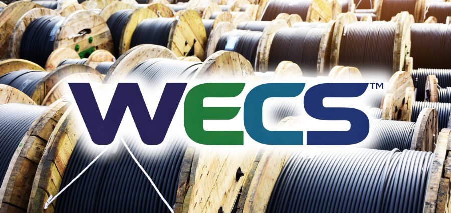 Wooden Coils Of Electric Cable Outdoor. High and low voltage cables in the storage.