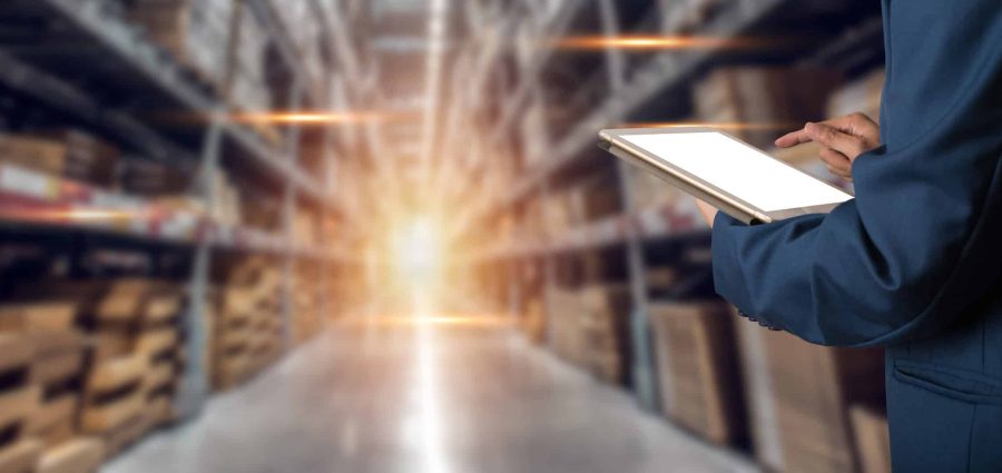 Factory worker using application on smart tablet to operate automation for modern trade. Import and export the shipping cargo of global logistic.