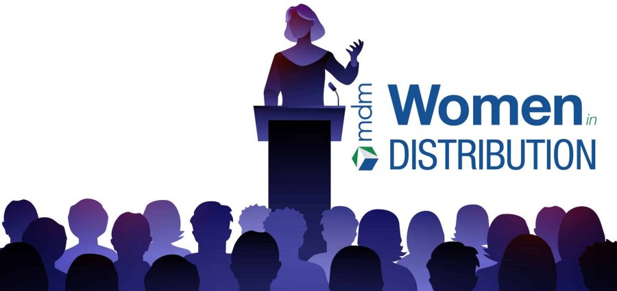 Female Public Speaker On Lectern In Front Of Audience.