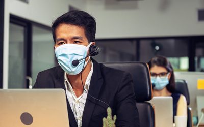 Young telephone operator with headset wear protection face mask against coronavirus, Customer service executive team working at office