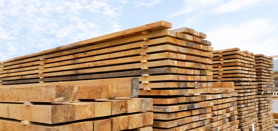 Stack of lumber and planks in a lumber warehouse outdoors