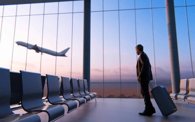 A businessman watching airplane in airport lounge