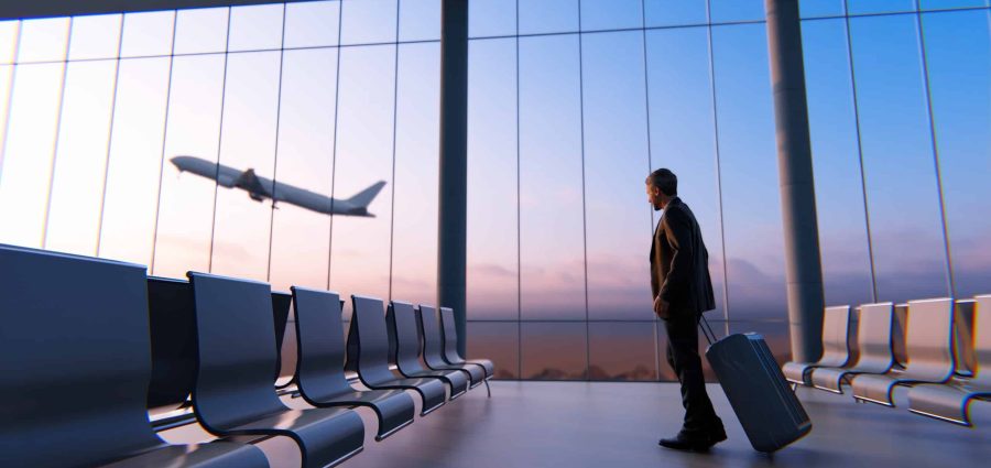 A businessman watching airplane in airport lounge
