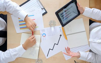 Businessman and businesswoman discussing at a meeting.