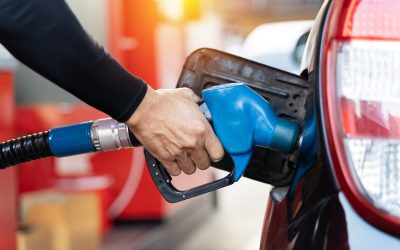 Refueling the car at a gas station fuel pump. Man driver hand refilling and pumping gasoline oil the car with fuel at he refuel station. Car refueling on petrol station. Fuel pump at station