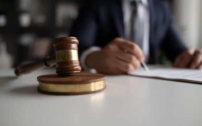 Judge or Legal advisor lawyer examining and signing legal documents.