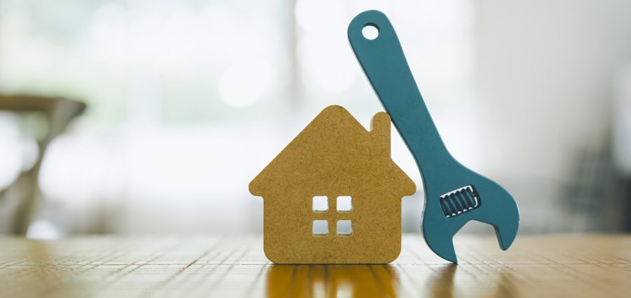Model house and wrench, home services. Home repairs concept.