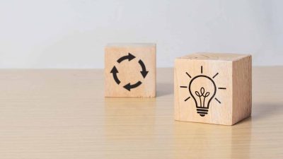 Wooden cube blocks with light bulb and cycle icons. Creative idea, solution and innovation concept. Idea generation for business development. clean background and copy space