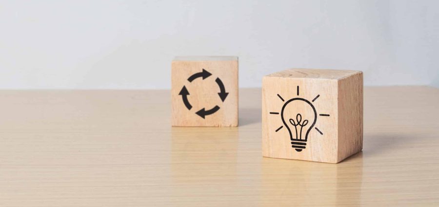 Wooden cube blocks with light bulb and cycle icons. Creative idea, solution and innovation concept. Idea generation for business development. clean background and copy space