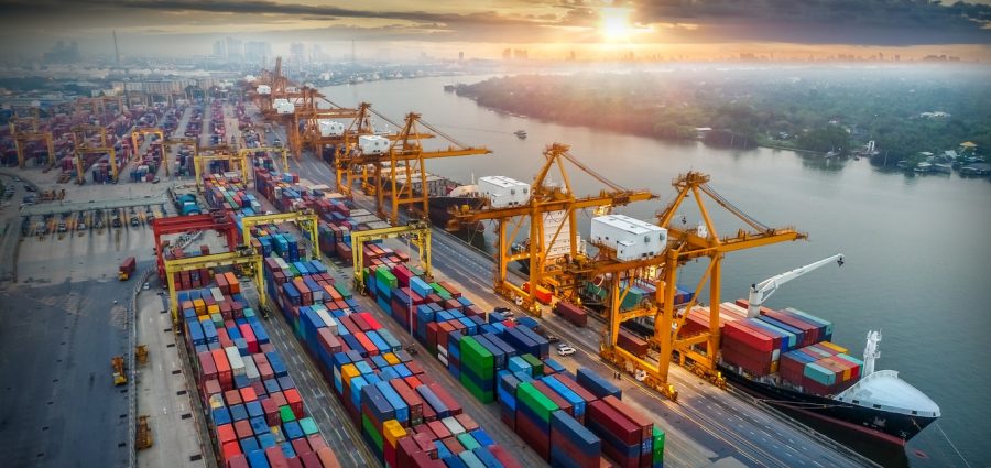 Logistics and transportation of Container Cargo ship and Cargo plane with working crane bridge in shipyard at sunrise, logistic import export and transport industry background